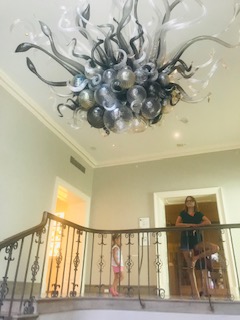 glass chandelier at top of staircase